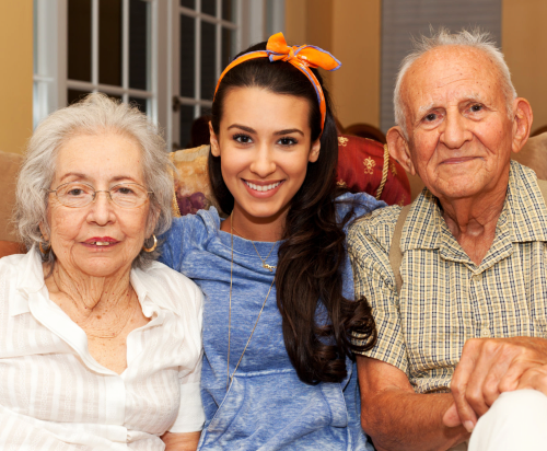 elderly couple with a caregiver